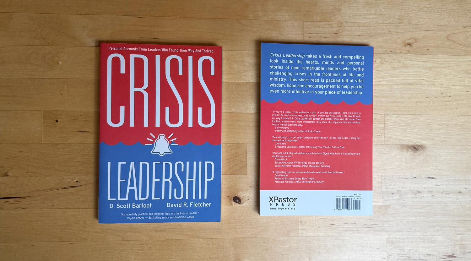 Front and back of the Crisis Leadership book on a wooden table.